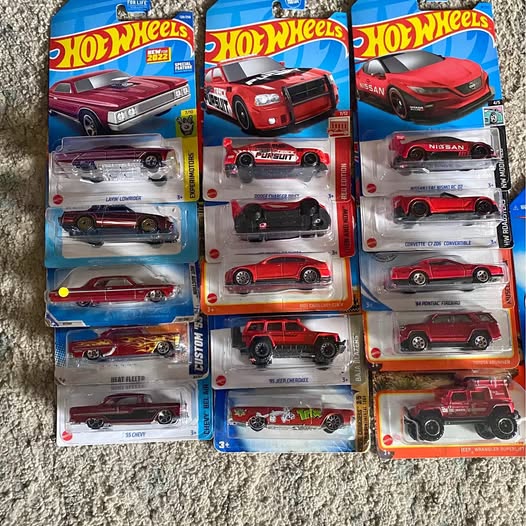 Hot Wheels diecast toy car blister pack with multiple red and dark cars