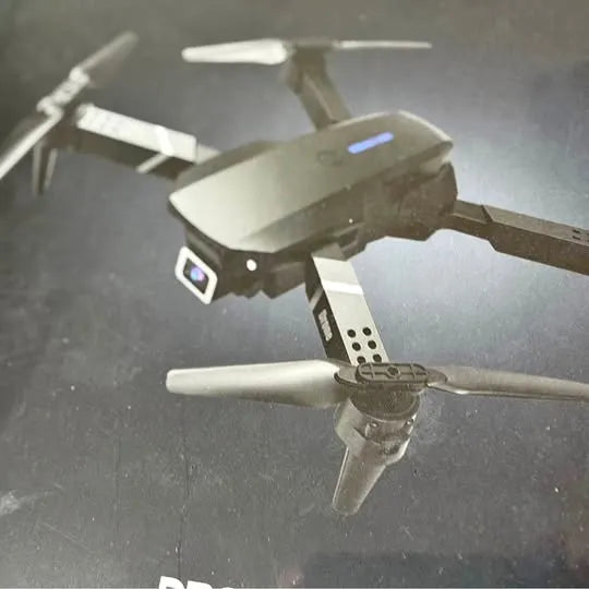 Camera drone with foldable propellers, gray body and front display