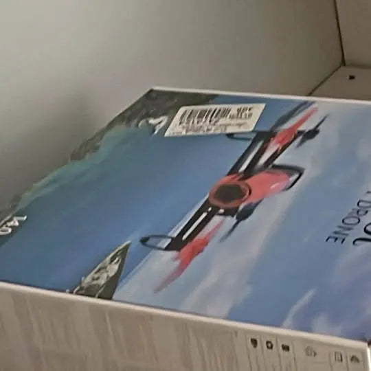 Printed drone shipping box lid, blue with red and black graphic and barcode