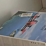 Printed drone shipping box lid, blue with red and black graphic and barcode