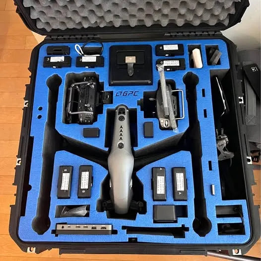Inspire 2 X7 drone kit in open hard case with drone, batteries, and tools