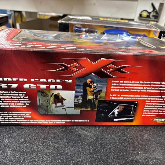 Red and black ERTL diecast car box with large X7X graphics and Camaro art