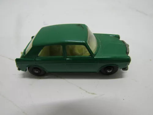 Vintage diecast toy car, green body with black wheels, side view