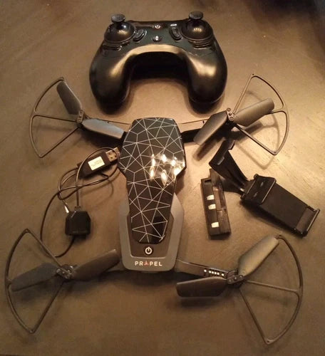 Compact folding drone with HD camera, four propellers, and handheld controller