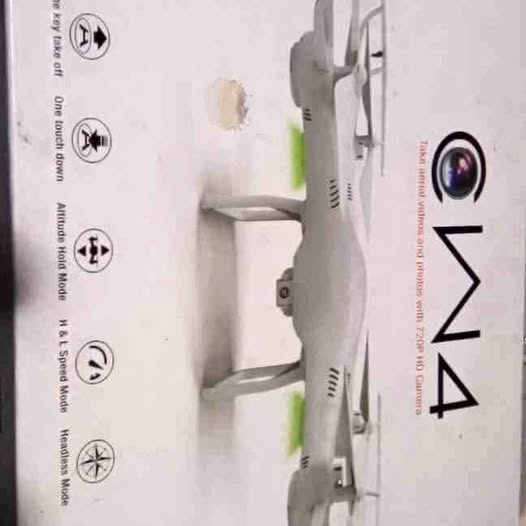Gray camera drone with front camera lens and landing gear, side view