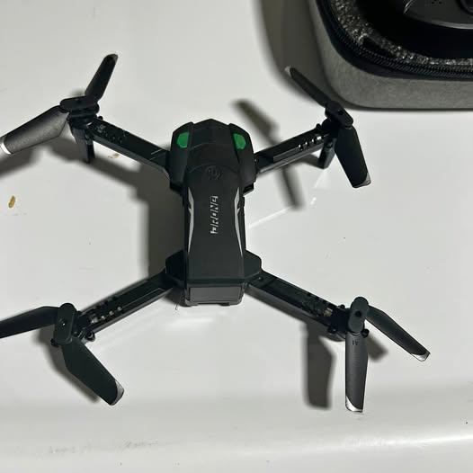 Foldable mini quadcopter drone with four propellers and front camera