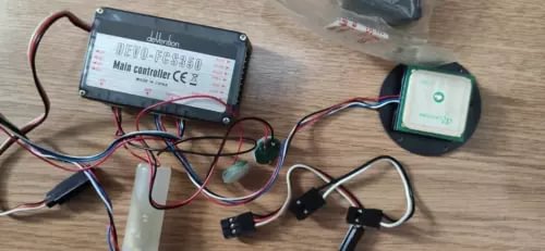 Drone controller module with attached cables and small receiver/transmitter units