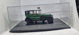 Green 1:43 scale diecast car model on clear display base with black wheels