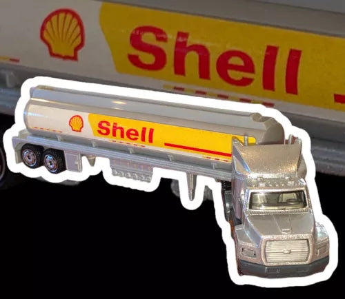 Silver diecast tractor with Shell yellow tanker trailer, Matchbox-style toy truck