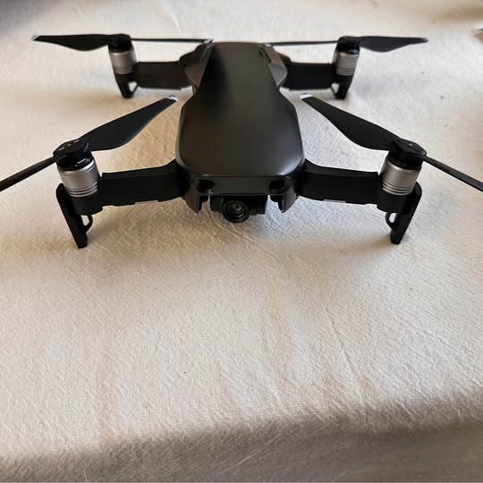 DJI Mavic Air drone with four propellers, dark gray body
