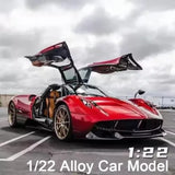 1:22 alloy diecast sport car model, red with open gullwing doors, front 3/4 view