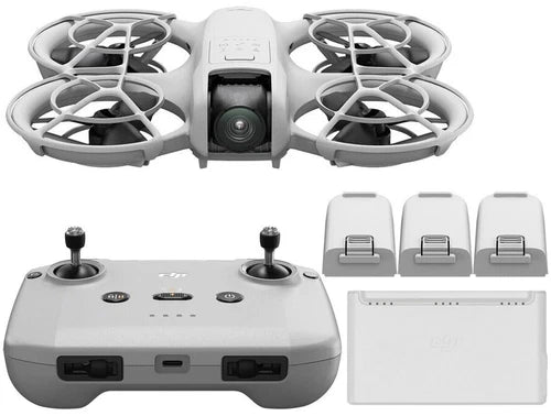 White quadcopter drone with camera, plus white controller and accessory battery modules