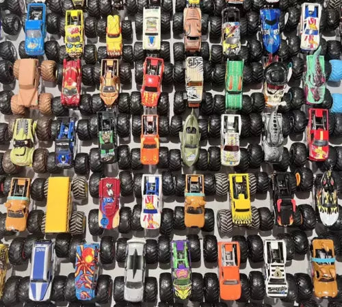 1:64 diecast monster truck assortment, large rugged tires, mixed colors.
