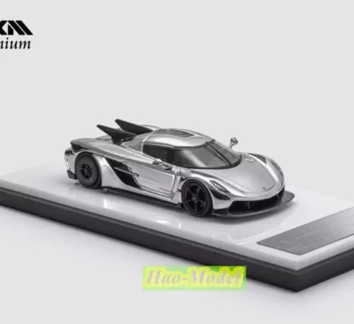 1:64 alloy diecast model car, silver with black accents, on display base