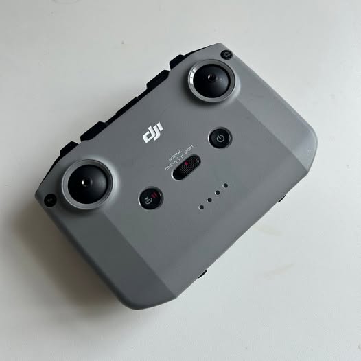 DJI Mini 2 controller with two circular joysticks and control buttons on gray body