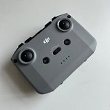 DJI Mini 2 controller with two circular joysticks and control buttons on gray body
