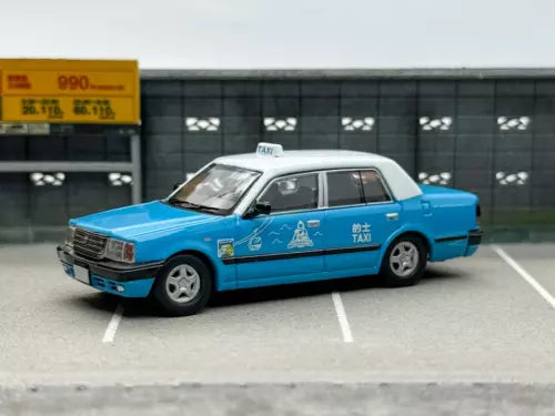 Blue diecast sedan car with taxi roof sign and side decals