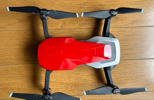 DJI Mavic Air drone with red body and four black propellers