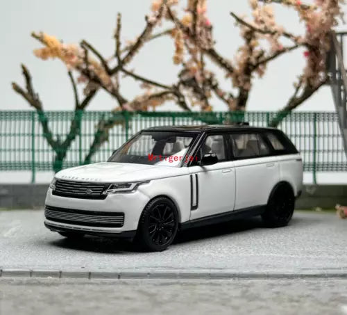 Diecast SUV model car, white 2022 Range Rover with black wheels, front view.