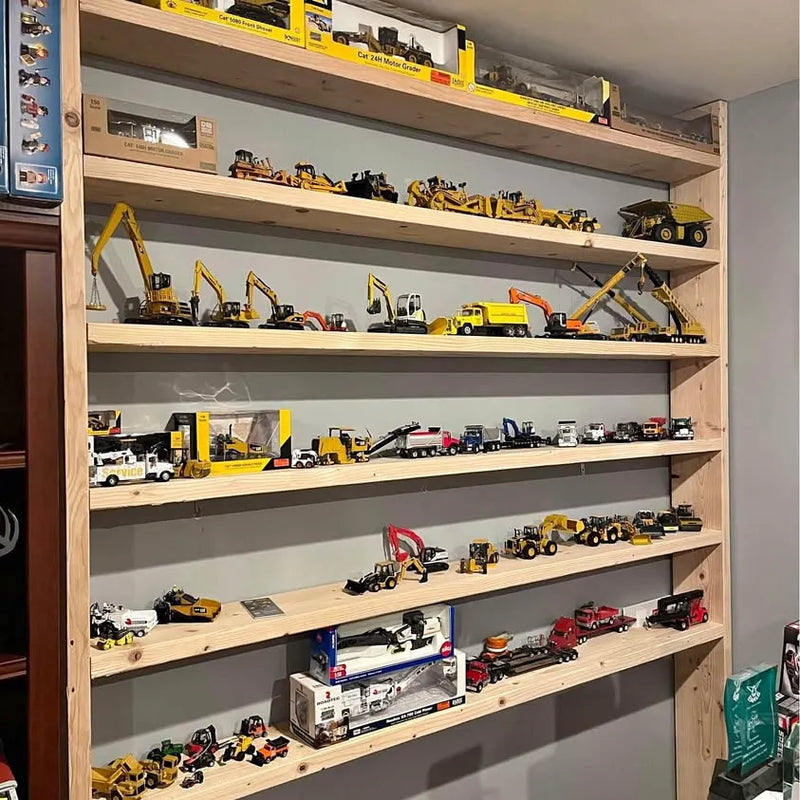 Assorted 1:50 Cat construction diecast vehicle models on display shelves
