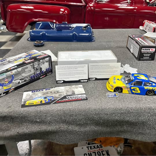 Blue and yellow #3 race car diecast with open display packaging and brochure