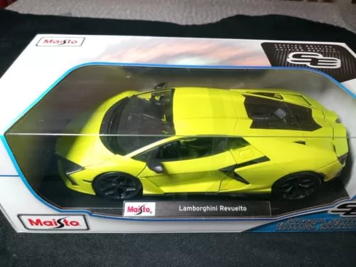 1:18 diecast model car with bright lime green body and black wheels in box
