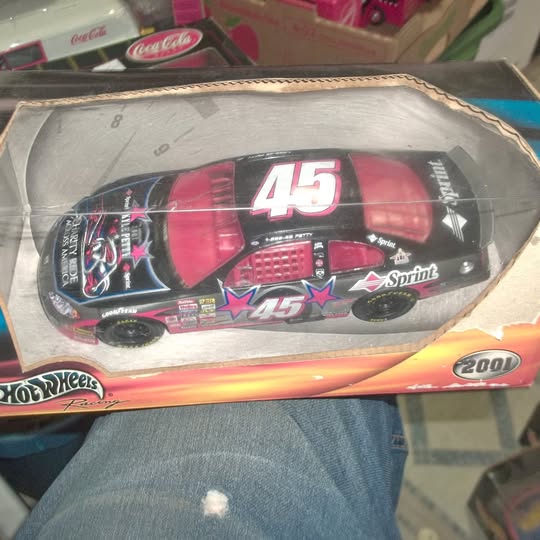 1:24 scale diecast race car, red with black decals and large number 45 on box
