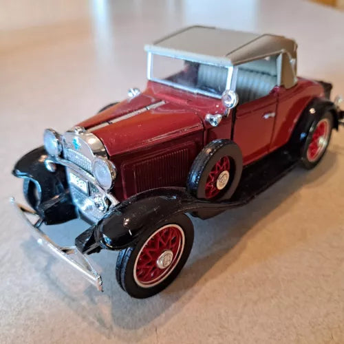 Red diecast sports cabriolet model car with chrome details and open top