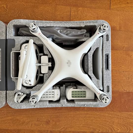 White DJI Phantom 4 Advanced drone with propellers inside hard case