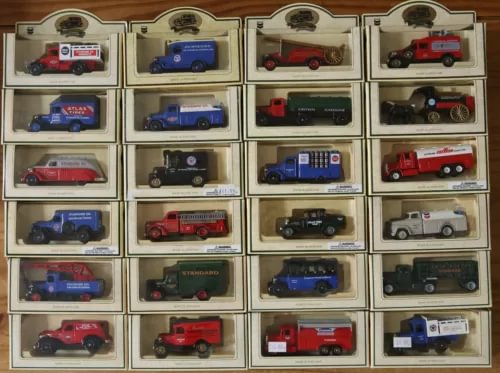 Diecast model car assortment in display boxes, various colored vehicles