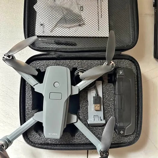 Light gray folding drone with four propellers, shown in a hard carrying case