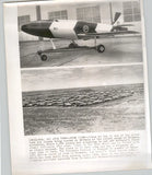 Vintage press photo of jet drone aircraft on runway with caption text