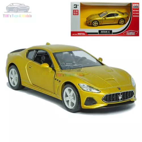 Gold Maserati GT diecast model car with white wheels, front 3/4 view and box
