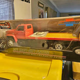 Orange die-cast heavy-duty flatbed truck model with open bed and chrome details