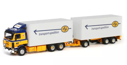 Yellow and white diecast truck model with long trailer, front cab and wheels visible