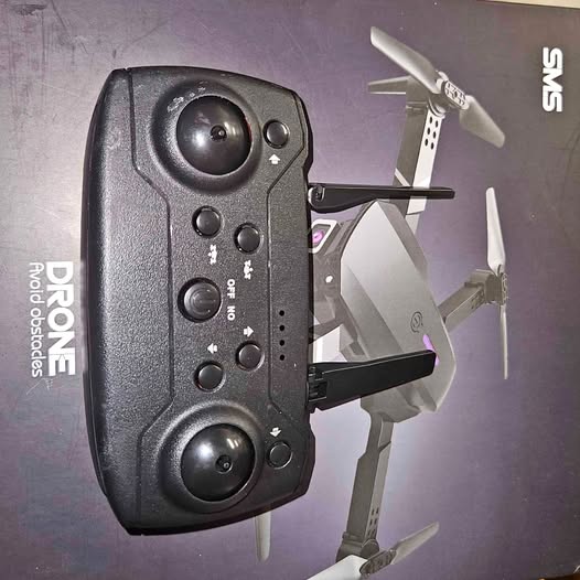 Dark quadcopter drone with remote controller and four propellers