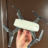 White DJI Spark drone with four foldable prop arms