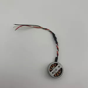 Mini drone replacement motor with attached red and black wires, circular housing