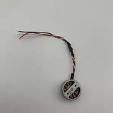 Mini drone replacement motor with attached red and black wires, circular housing