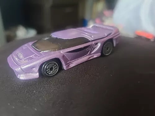 Purple vintage diecast retro car with black windows and detailed wheels.