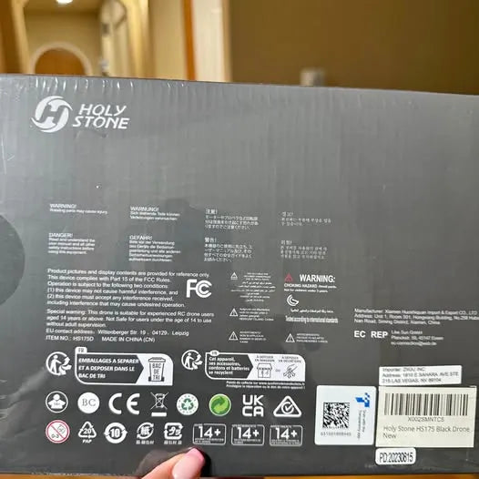 GPS drone package with warning and certification labels, black text on gray box