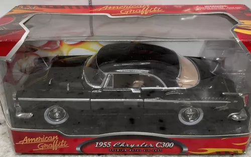 Black 1955 Chrysler C300 diecast car in retail box, front view with wheels visible