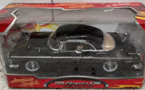 Black 1955 Chrysler C300 diecast car in retail box, front view with wheels visible