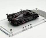 1:64 diecast racing sports car, black with pink accents, on clear display base
