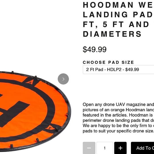 Orange circular drone landing pad with black lettering and arrows