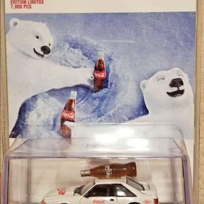 White diecast car in clear blister package, red accents on hood