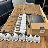 Set of white dome security cameras with wiring and power module