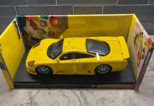 Yellow diecast model car, 1:18 scale, in display box with clear cover