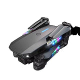 Mini toy drone with dark gray body and multicolor LED lights, front camera housing