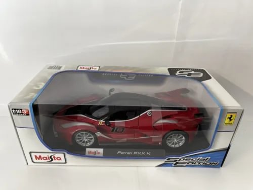 Red Ferrari FXX K diecast car in clear display box, 1:18 scale